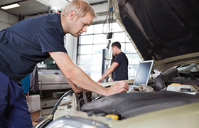 Mechanic working on a car covered by Business Auto Insurance in Westchase, FL