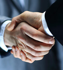 Two businessmen shaking hands agreeing to Insurance agency in Tampa, FL